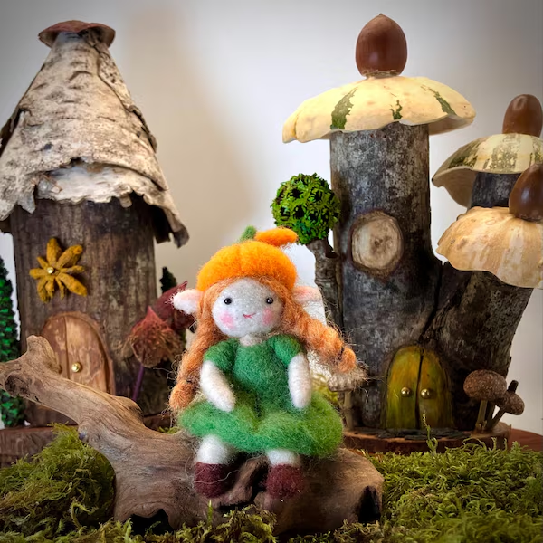 A custom handmade wool fairy in a woodland setting