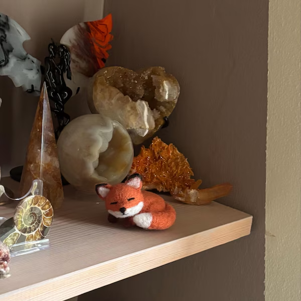 A small needle-felted fox on a shelf